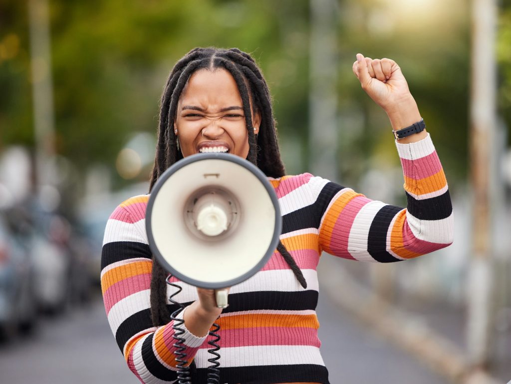 Megaphone, city or black woman in protest with speech announcement for politics, equality or human